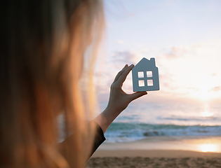 Image showing Wooden figurine of house in female hands