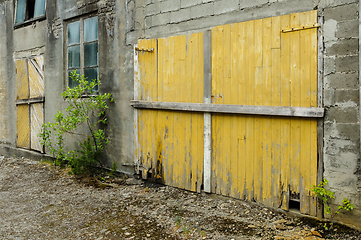 Image showing old front doors and glass in the brick wall