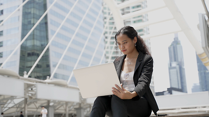 Image showing Portrait of young asian businesswoman working on laptop