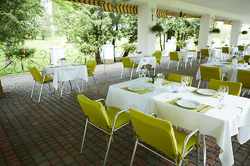 Image showing terrace summer cafe with tables and chairs for people, an empty institution for recreation, nobody