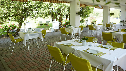 Image showing terrace summer cafe with tables and chairs for people, an empty institution for recreation, nobody