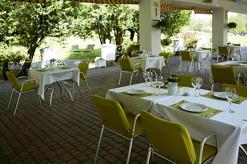 Image showing terrace summer cafe with tables and chairs for people, an empty institution for recreation, nobody