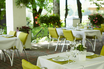 Image showing terrace summer cafe with tables and chairs for people, an empty institution for recreation, nobody