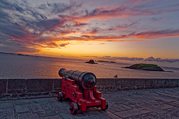 Image showing Ancient weapons on the fortress against the backdrop of the ocean and orange sky