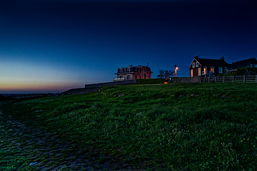 Image showing Houses on a picturesque hill overlooking the ocean. beautiful night scenery