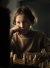 Image showing The teenager made a move while playing chess