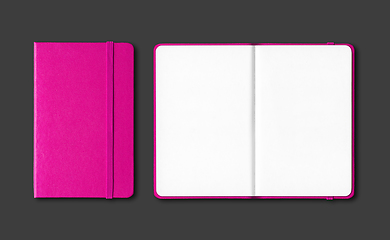 Image showing Pink closed and open notebooks isolated on black