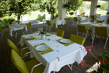 Image showing terrace summer cafe with tables and chairs for people, an empty institution for recreation, nobody