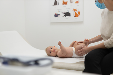 Image showing Baby lying on his back during a standard medical checkup at pediatrician