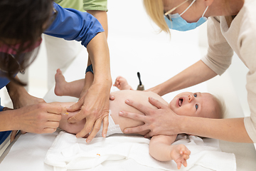 Image showing Baby beeing vaccinated by pediatrician in presence of his mother. Preventive vaccination against Diphtheria, whooping cough, tetanus, hepatitis, haemophilus influenzae, pneumococcus, poliomyelitis