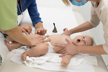 Image showing Baby beeing vaccinated by pediatrician in presence of his mother. Preventive vaccination against Diphtheria, whooping cough, tetanus, hepatitis, haemophilus influenzae, pneumococcus, poliomyelitis