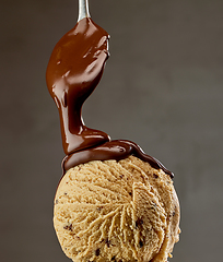 Image showing melted chocolate sauce flowing on ice cream