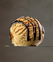 Image showing caramel ice cream scoop with chocolate sauce