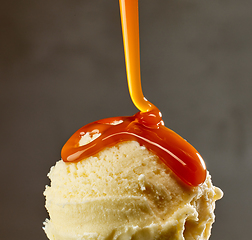 Image showing caramel sauce flowing on vanilla ice cream