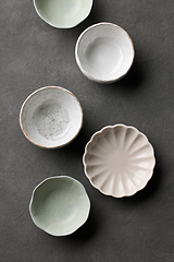 Image showing various empty bowls on dark grey background