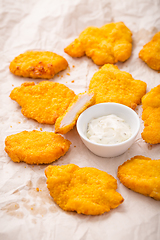 Image showing Small chicken schnitzel on baking sheet with herb mayonnaise 