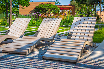 Image showing Modern wooden deck chairs or chaise longues for patio or garden