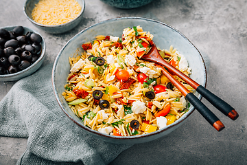 Image showing Homemade orzo pasta salad with feta, olives, tomatoes