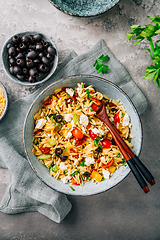 Image showing Homemade orzo pasta salad with feta, olives, tomatoes