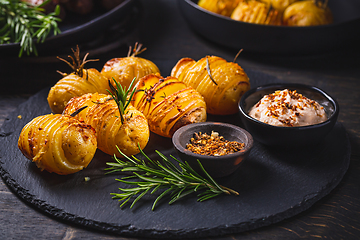 Image showing Hasselback potatoes with additional herbs, spices and whipped feta dip