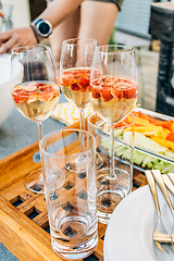 Image showing Summer strawberry wine cocktails with healthy snacks on terrace