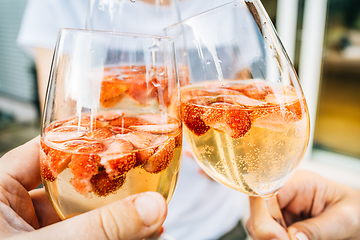 Image showing Summer strawberry wine cocktail, toasting with refreshing drinks