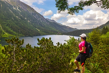 Image showing A tourist admiring the mountain lake called Morskie Oko in Tatra mountains Poland