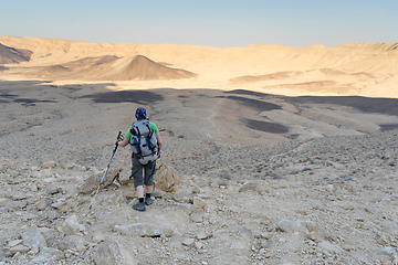 Image showing Hiking tourist in desert trek adventure