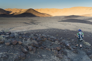 Image showing Hiking tourist in desert trek adventure