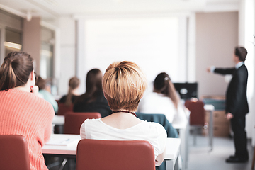 Image showing Speaker Giving a Talk at Business Meeting. Audience in the conference hall. Business and Entrepreneurship. Copy space on white board