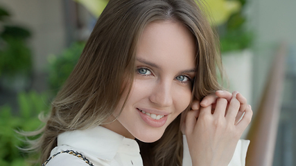 Image showing Radiant Smiling Woman with Long Blond Hair in Headshot Portrait