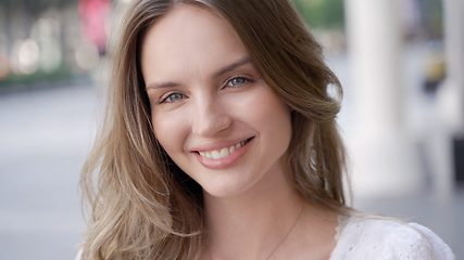 Image showing A smiling young adult with long hair in a headshot portrait