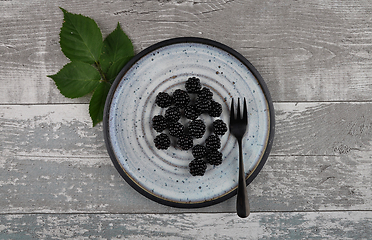 Image showing Blackberries on plate and weathered wood