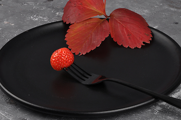 Image showing Strawberry on fork and plate