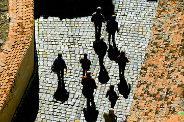 Image showing people walking by cobblestone street 