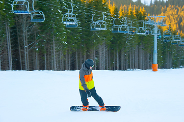 Image showing Boy riding snowboard