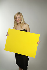 Image showing blond woman yellow sign