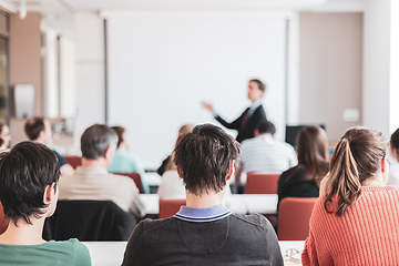 Image showing Speaker Giving a Talk at Business Meeting. Audience in the conference hall. Business and Entrepreneurship. Copy space on white board