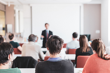 Image showing Speaker Giving a Talk at Business Meeting. Audience in the conference hall. Business and Entrepreneurship. Copy space on white board