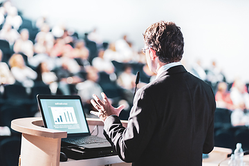 Image showing Speaker at Business Conference with Public Presentations. Audience at the conference hall. Entrepreneurship club. Rear view. Horisontal composition. Background blur