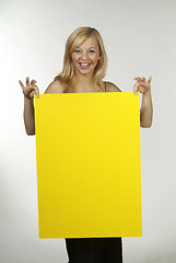 Image showing blond woman yellow sign