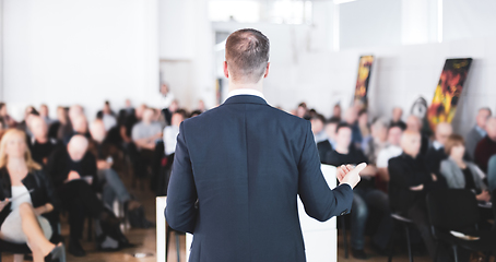 Image showing Speaker at Business Conference with Public Presentations. Audience at the conference hall. Entrepreneurship club. Rear view. Horisontal composition. Background blur