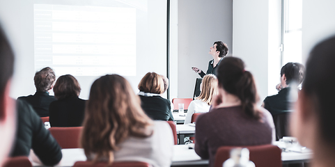 Image showing Woman giving presentation in lecture hall at university.