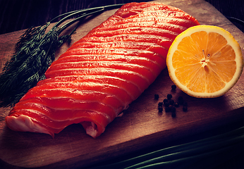 Image showing Fresh salmon piece on wooden board
