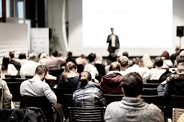 Image showing Speaker at Business Conference with Public Presentations. Audience at the conference hall. Entrepreneurship club. Rear view. Horisontal composition. Background blur