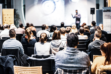 Image showing Speaker giving a talk in conference hall at business event. Audience at the conference hall. Business and Entrepreneurship concept. Focus on unrecognizable people in audience