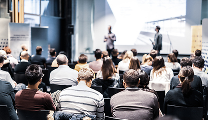 Image showing Speaker giving a talk in conference hall at business event. Audience at the conference hall. Business and Entrepreneurship concept. Focus on unrecognizable people in audience