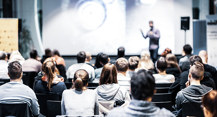 Image showing Speaker giving a talk in conference hall at business event. Audience at the conference hall. Business and Entrepreneurship concept. Focus on unrecognizable people in audience