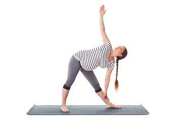 Image showing Pregnant woman doing yoga asana Utthita trikonasana