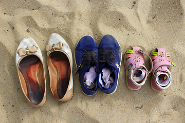 Image showing footwear left by mother and her daughters